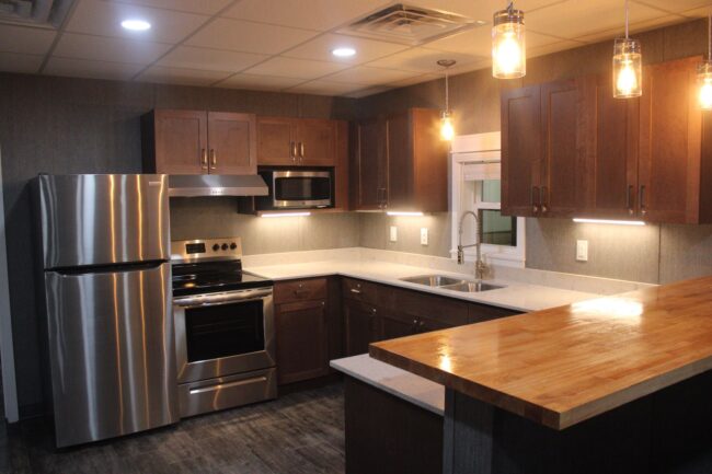 interior view. kitchen. stainless appliances fridge stove microwave. shows counter and cabinets